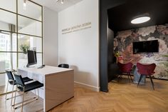 an office with wooden floors and white walls