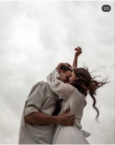 a man and woman are kissing in the air