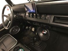 the interior of a car with an electronic device in the center console and other accessories