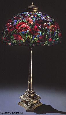 a stained glass lamp sitting on top of a table