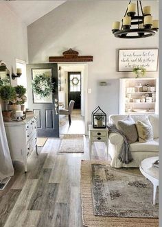 a living room filled with lots of furniture and decor on top of wooden flooring