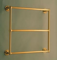 an old fashioned brass towel rack on the wall