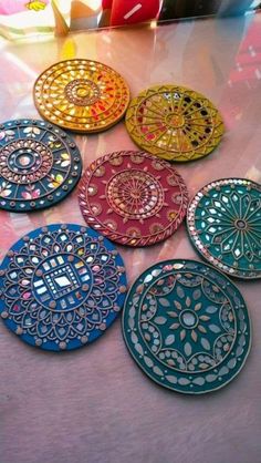 six decorative plates sitting on top of a table