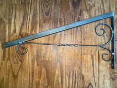 an old iron shelf bracket on a wood floor