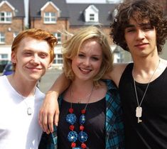 three young people standing next to each other