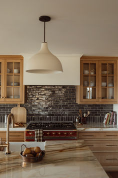 a kitchen with marble counter tops and wooden cabinets