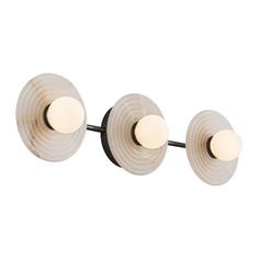 three lights that are on the side of a wall mounted light fixture, one is white and