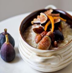 a bowl of oatmeal with figs on the side