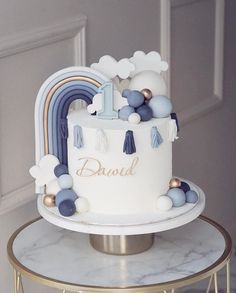 a white cake with blue and gold decorations