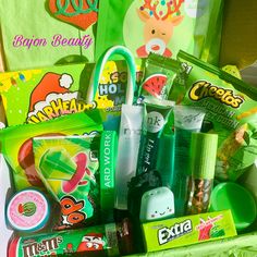 a green box filled with lots of different types of candy