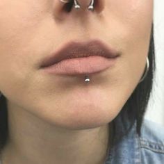 a woman with piercings on her nose