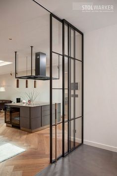 an open living room and kitchen area with sliding glass doors