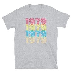 a gray t - shirt with the words 1971 in multicolored letters on it