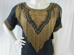 "Vintage black silk heavily embellished gold beads and fringe Jane Ashely evening top with original tags. Unbelievable workmanship! Tons of gold beading in a paisley pattern with a knockout layer of long beaded fringe across the front. This top will get you noticed! Perfect condition with original tags! Tag reads size M. Pair this with some palazzo pants and you will trip the light fantastic:) Measured flat Shoulders 19\" Bust 38\" Waist 38\" Length 23\"" Gold Beaded Evening Tops, Fitted Fringe Tops For Evening, Fitted Beaded Fringe Tops For Evening, Trip The Light Fantastic, Evening Tops, Beaded Fringe, Paisley Pattern, Palazzo Pants, Black Silk