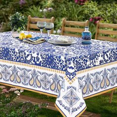 a blue and white table cloth on a wooden bench