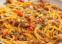 a white bowl filled with spaghetti and meat