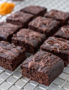 chocolate brownies with frosting on a cooling rack