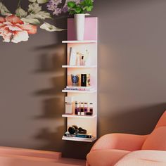 a pink chair sitting next to a white shelf filled with bottles and cosmetics on top of it