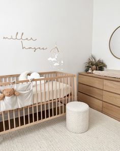 a baby's room with a crib and dresser