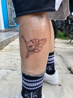 a man's leg with a tattoo on it and an image of a bat