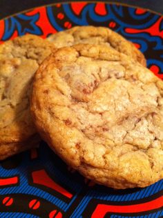 two cookies sitting on top of a blue and red plate