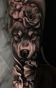 a black and white photo of a wolf with flowers on his arm