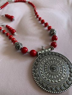 A stunningly ornate, imported locket serves as the centerpiece of this eye-catching necklace with fire engine red beads and silver embellishments; with matching earrings; Beaded Jewelry Designs, Fire Engine, Red Bead, Matching Earrings, Locket, Jewelry Sets, Beaded Jewelry, Beaded Necklace, Jewelry Design