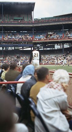 people sitting in the stands at a baseball game