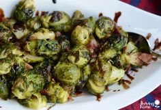 brussel sprouts on a plate with sauce drizzled over them