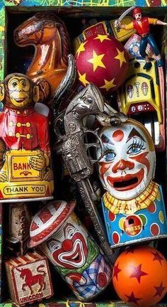 a box filled with lots of different types of clown faces and toys in it's opening