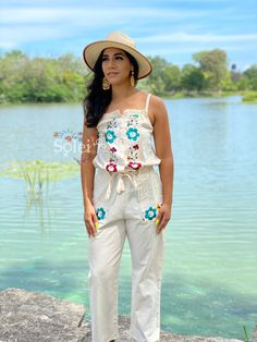 This modern style jumpsuit with beautiful traditional embroidered flowers is the perfect look for this season. It is a slim fitting romper with elastic on the back, buttons in the front and a tie around the waist. It also has embroidered pockets on each side. This jumpsuit is hand embroidered in Silk Thread with love for you by Mexican Artisans. Cotton Jumpsuits And Rompers For Summer Festivals, Spring Festival Jumpsuits And Rompers, Embroidered Cotton Jumpsuits And Rompers For Spring, Embroidered Fitted Sleeveless Jumpsuits And Rompers, Fitted Cotton Jumpsuit For Beach, Casual Embroidered Jumpsuits And Rompers For Spring, Embroidered Cotton Jumpsuits And Rompers For Summer, Sleeveless Embroidered Jumpsuits And Rompers For Summer, Embroidered Fitted Jumpsuits And Rompers For Spring