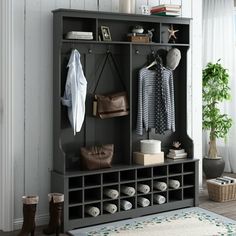 an entryway with a bench, coat rack and purses