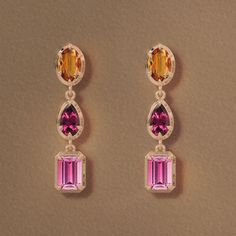 A trio of vibrant gemstones are set in bezel edged modern settings and linked together for a subtle movement. From top to bottom Citrine Oval Cut .47Cts, Rhodalite Garnet Pear cut .37cts, Pink Tourmaline Emerald Cut .7Cts, total Carat weight is 3.08 Cts. These stones are ethically sourced and carefully selected for their vibrant rich color. Modern Three Stone Yellow Gold Jewelry, Yellow Gold Three Stone Gemstones Fine Jewelry, Pink Tourmaline Necklace, Ultrasonic Jewelry Cleaner, Experimental Design, Tourmaline Necklace, Lip Service, Ethical Jewelry, Sustainable Jewelry