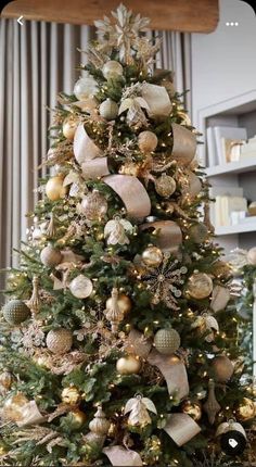 a christmas tree decorated with gold and silver ornaments