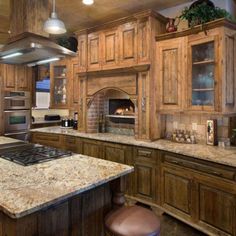 a large kitchen with an oven, stove and counter tops in the middle of it