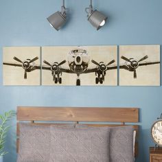 an airplane is hanging on the wall above a bed