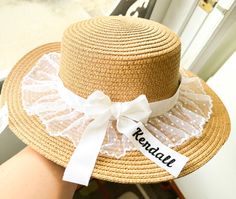 Elevate your bridal look with this charming, personalized bridal sun hat, perfect for beach weddings, honeymoons, or bridal showers. It is adorned with delicate lace trim and a chic white ribbon bow, adding a romantic touch to your outfit. The wide brim ensures protection from the sun while keeping you stylish. The embroidered name, elegantly placed on the ribbon, adds a unique and thoughtful personalization to the hat. Whether you're a bride, bridesmaid, or guest, this hat makes the perfect accessory or gift for any bridal event! ------ Size One size fits most ------ Color  Hat: 6 colors Lace: White only 1'' Ribbon: 19 colors ------ Personalized bridal sun hat Custom wedding sun hat Bridal beach hat Embroidered name hat for brides Bride honeymoon sun hat Custom embroidered sun hat Lace-tr White Ribbon Bow, Personalized Bridal Shower Gifts, Weddings Beach, Bride Hat, Honeymoon Gifts, Beach Bride, Beach Bridal, Hat Custom, Embroidered Name