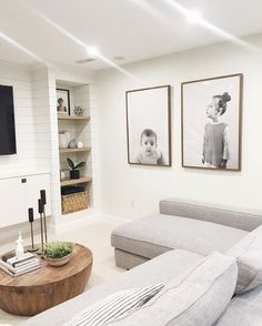 a living room filled with furniture and pictures on the wall