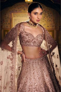 This lehenga set features all over three-dimensional floral embroidery, along with mix zardozi and crystal elements on a raw silk base. The ensemble is paired with an embroidered sweetheart neck blouse and the worked dupatta has a rose gold fringe on all four sides. From Seema Gujral’s Samode collectionDELIVERY TIMEPlease wait 8-12 weeks for your outfit to arrive.FABRIC DETAILSRaw SilkProfessional cleaning only. Lehenga Blouse Designs Latest, Sweetheart Neck Blouse, Shadi Dress, Wedding Fits, Gold Lehenga, Party Wear Gowns, Saree Blouse Styles