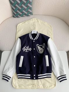 Embrace a sophisticated take on varsity style with this LV-inspired Calfskin Navy Varsity Jacket. Crafted from a luxurious blend of navy blue wool and supple calfskin leather, this jacket exudes timeless elegance. The contrasting white sleeves and ribbed detailing add a sporty touch, while the meticulously embroidered Louis Vuitton-inspired script and graphic on the chest elevate the design. This versatile jacket is perfect for layering and adding a touch of luxury to any casual ensemble. Louis Vuitton College Jacket, Navy Varsity Jacket, Lv Inspired, White Sleeves, Fall Winter Jacket, Drew Starkey, Versatile Jacket, Varsity Style, Fashion Revolution