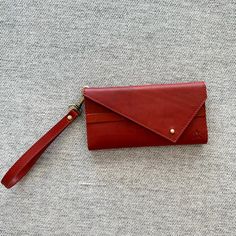 Timeless And Unique Full-Gran Leather Wallet That Is Also Ethically And Thoughtfully Made. Meet Elevate's Tri-Fold Wallet/Wristlet. Mahogany Color. It Also Comes In 2 Other Colors: Black And Camel. Our #1 Best Seller, The Tri-Fold Wallet Is Timeless And Unique. Multiple Folds Keep Your Cards And Cash Secure. The Front Flap Closes With A Cute Brass Peg - And We Made It Twice As Thick To Provide Double Durability For Everyday Use. Use The Detachable Wristlet For On-The-Go Convenience, Or Tuck The Elegant Red Trifold Wallet For Everyday Use, Red Trifold Wallet For Daily Use, Red Leather Trifold Wallet, Red Wallets With Removable Pouch, Red Leather Wallet With Removable Pouch, Ysl Wallet, Betsey Johnson Wallet, Wrist Wallet, Louis Vuitton Capucines