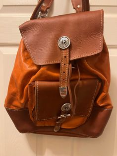 Black and orange leather backpack Designer Brown Leather Backpack For Daily Use, Designer Orange Leather Bags, Designer Brown Backpack For School, Orange Leather Travel Bag, Cognac Leather Backpack, Designer Brown Leather Backpack, Casual Brown Leather Backpack With Leather Lining, Designer Brown Backpack For Everyday, Orange Leather Bags With Leather Lining