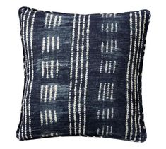 a black and white pillow with stripes on the front, in an ethnic style pattern