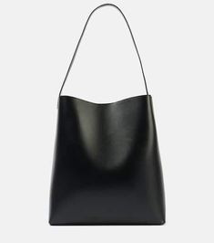 Sac Large leather tote bag in black - Aesther Ekme | Mytheresa Calf Leather Tote Shoulder Bag For Work, Black Calf Leather Shopping Bag, Modern Shoulder Bag With Leather Handles In Calf Leather, Minimalist Formal Bag With Leather Lining, Modern Shoulder Bag With Calf Leather And Leather Handles, Black Calf Leather Bag With Removable Pouch, Modern Calf Leather Shoulder Bag With Leather Handles, Business Calf Leather Bucket Shoulder Bag, Black Calf Leather Shoulder Bag With Leather Handles