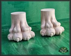 two wooden feet are shown on a green surface