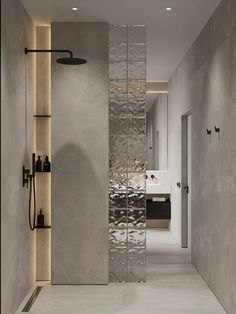 a bathroom with a shower head, sink and mirror on the wall next to it