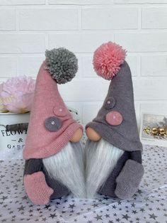 two gnomes with hats on sitting next to each other