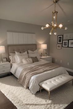 a bedroom with a large bed and white furniture