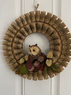 a wreath made out of wine corks with an owl on it