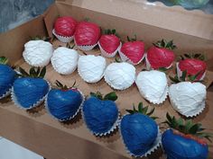 a box filled with chocolate covered strawberries on top of a table